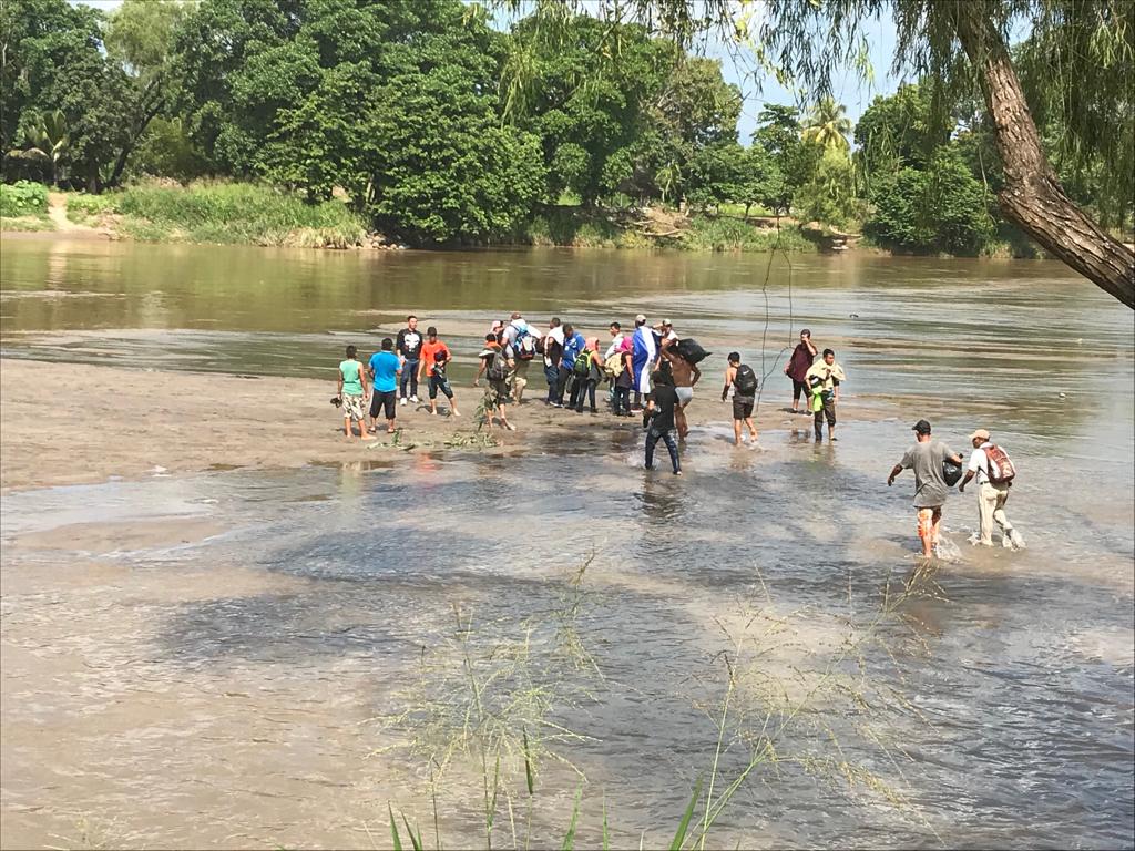 Cientos de migrantes cruzan rio